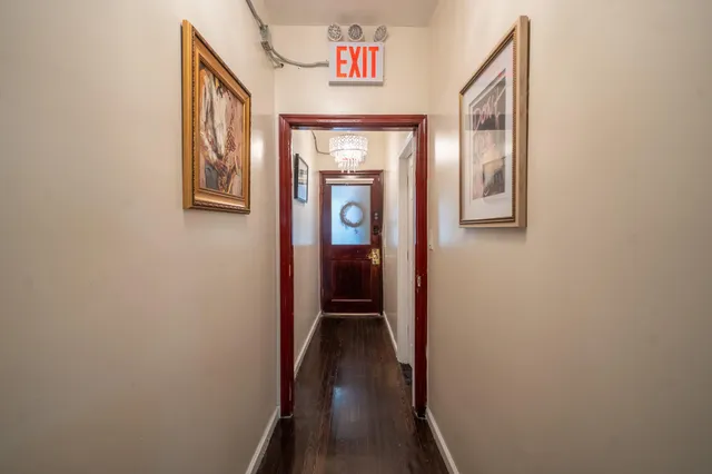 a view of an entryway door with hallway