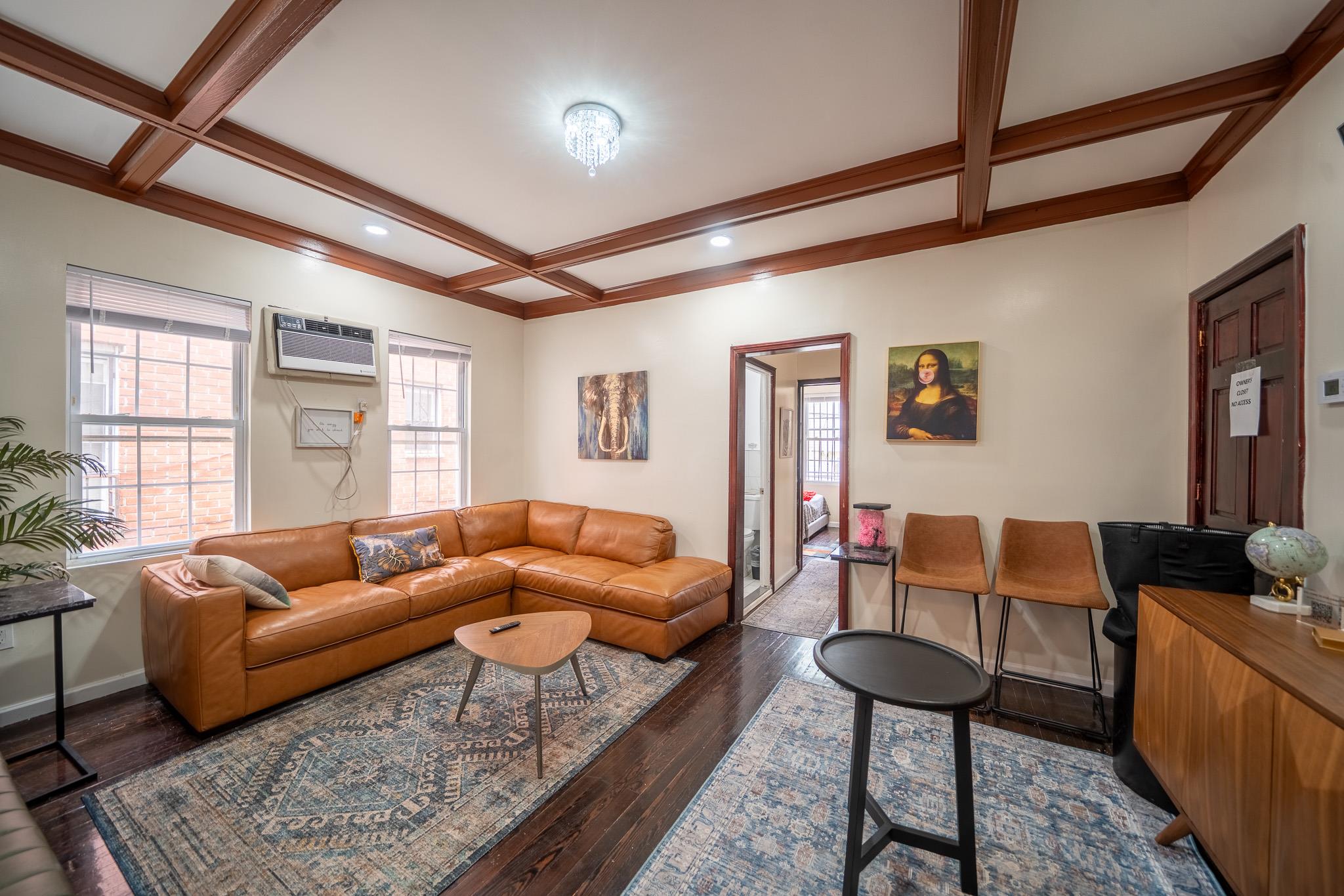 104-21 Lefferts Boulevard Queens, NY 11419 - Photo 5 of 29 a living room with furniture and a large window