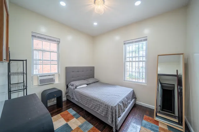 a bedroom with a bed and a chandelier