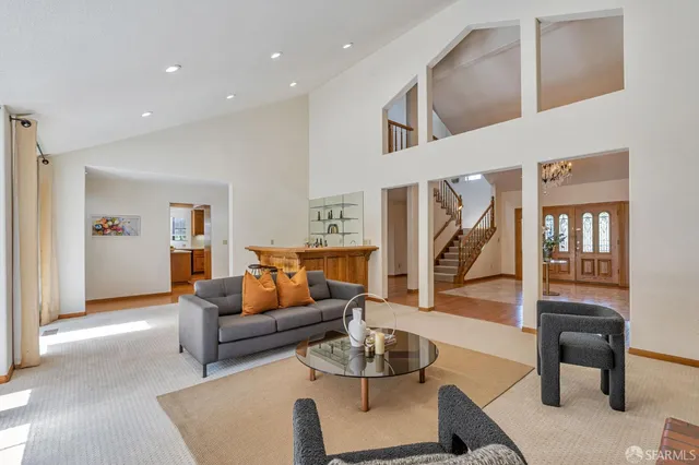a spacious bedroom with a large bed and a chandelier