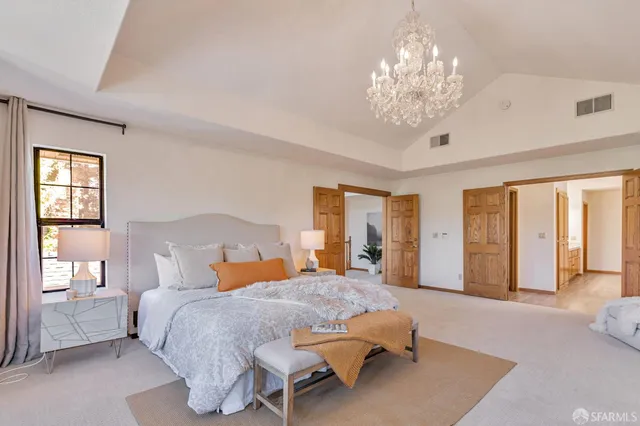 a kitchen with a sink and a stove with wooden floor