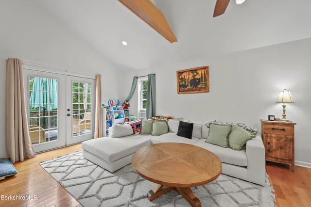 a living room with furniture and a floor to ceiling window
