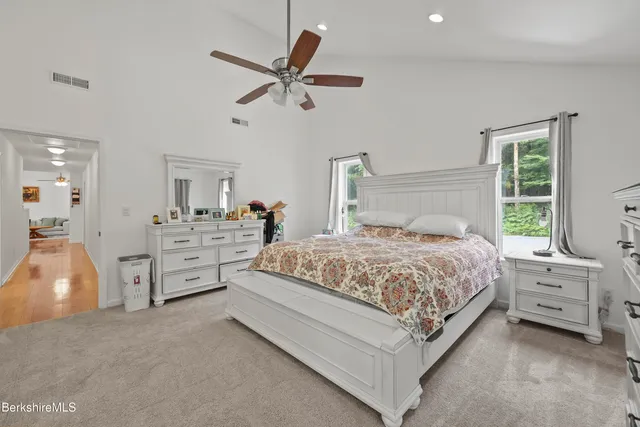 a bathroom with a granite countertop shower a toilet and a sink