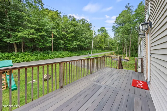 a view of balcony with wooden floor and fence