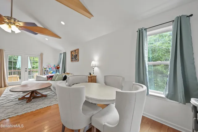 a living room with furniture a lamp and a large window