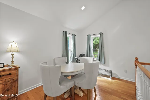 a view of a dining room with furniture window and wooden floor