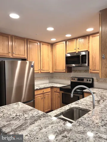 a kitchen with a sink and a refrigerator