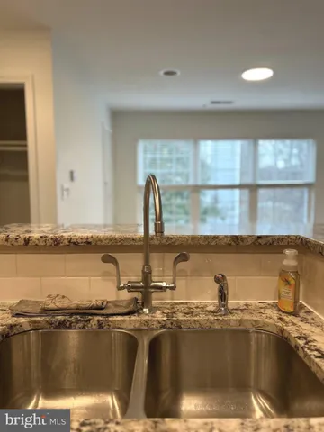 a view of a kitchen with a sink and a refrigerator