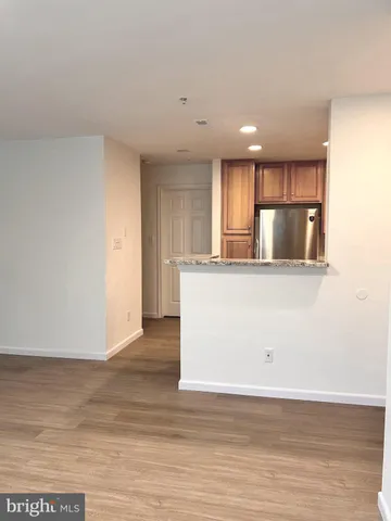 a view of a refrigerator in kitchen and wooden floor