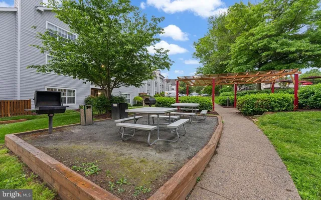 an aerial view of a house having patio with a garden