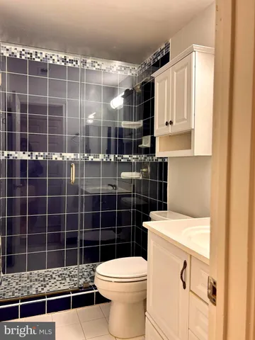 a bathroom with a toilet a sink and shower