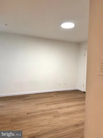 a view of an empty room and wooden floor