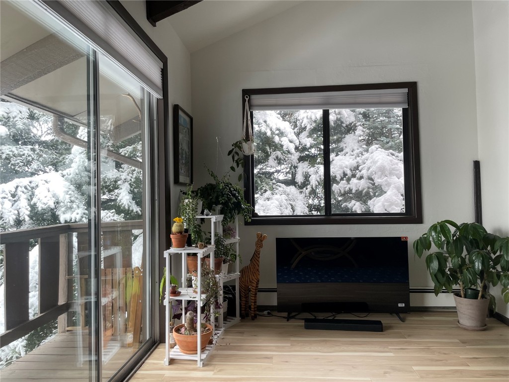 2099 Chamonix Lane, Unit 1A Vail, CO 81657 - Photo 17 of 29 a living room with a fireplace and large windows