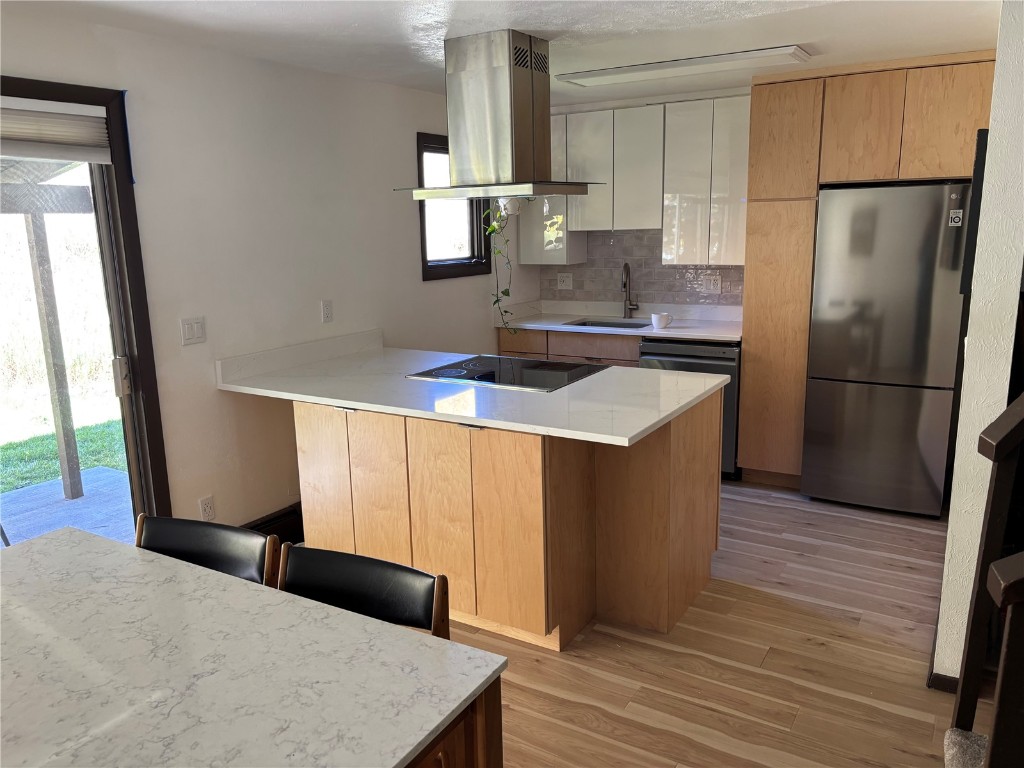 2099 Chamonix Lane, Unit 1A Vail, CO 81657 - Photo 3 of 29 a kitchen with stainless steel appliances granite countertop a refrigerator a stove and a wooden floors