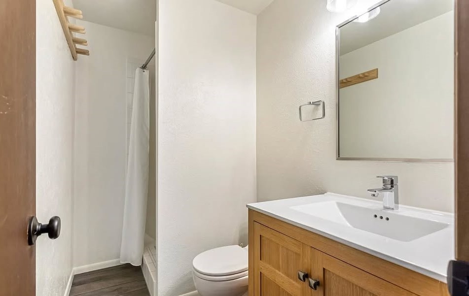 2099 Chamonix Lane, Unit 1A Vail, CO 81657 - Photo 9 of 29 a bathroom with a sink a toilet and shower