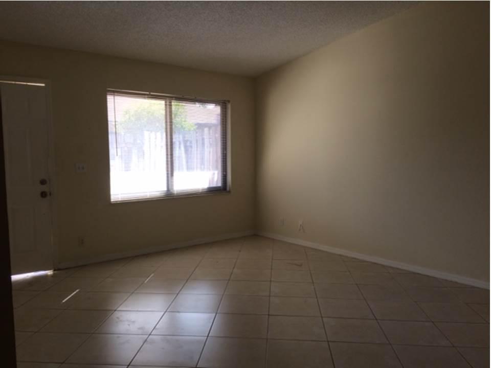 4328 Woodstock Drive, Unit D West Palm Beach, FL 33409 - Photo 3 of 9 a view of an empty room with a window