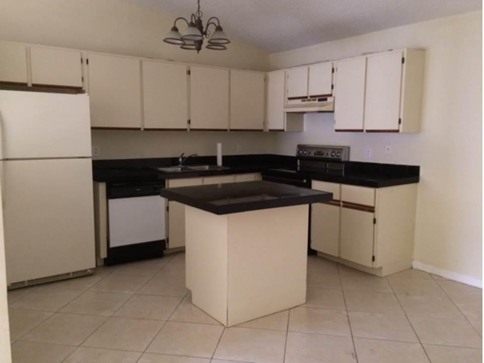 4328 Woodstock Drive, Unit D West Palm Beach, FL 33409 - Photo 5 of 9 a kitchen with a sink and cabinets