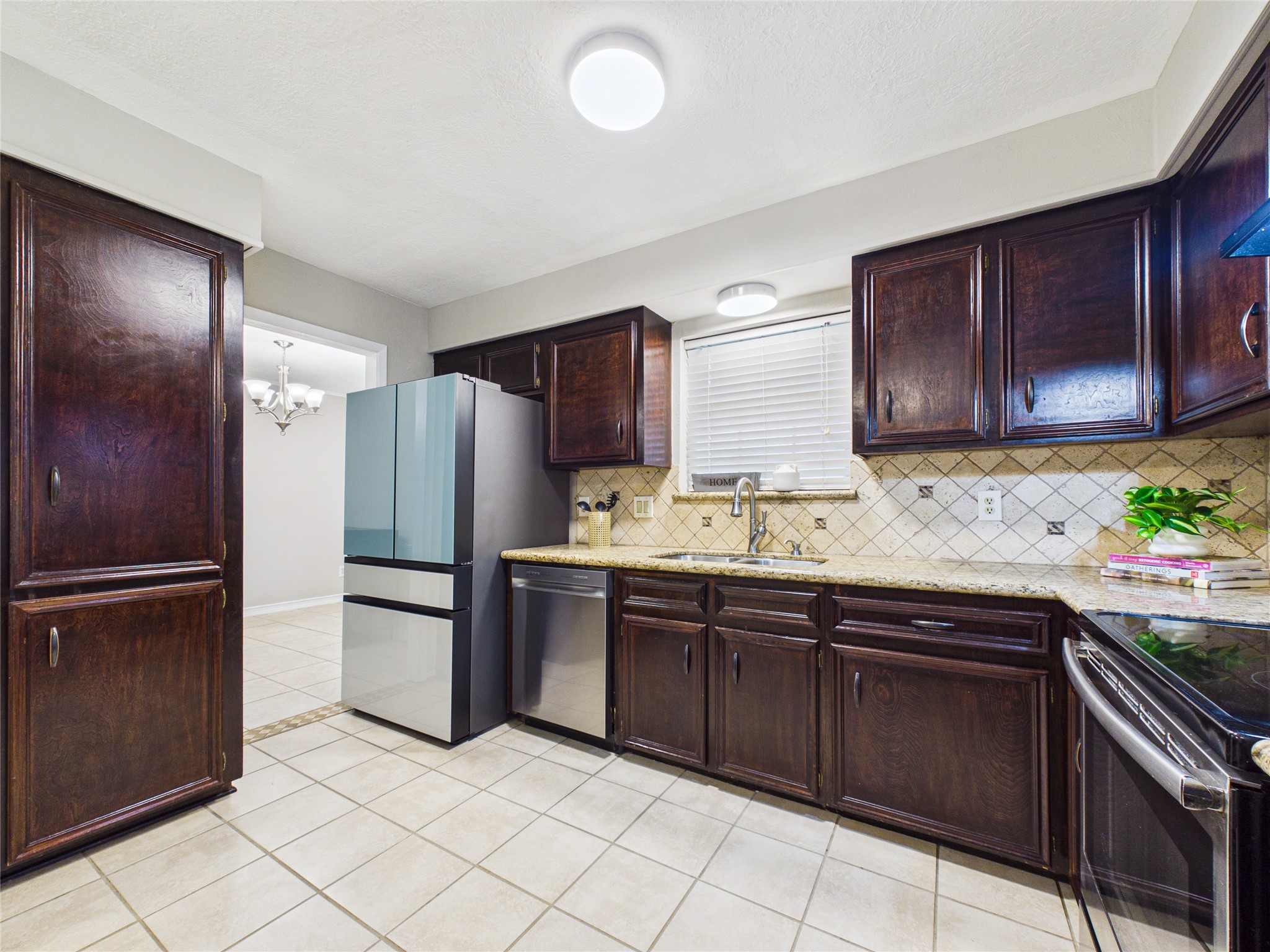 10306 Rustic Rock Road La Porte, TX 77571 - Photo 12 of 38 a kitchen with stainless steel appliances granite countertop a refrigerator and a sink