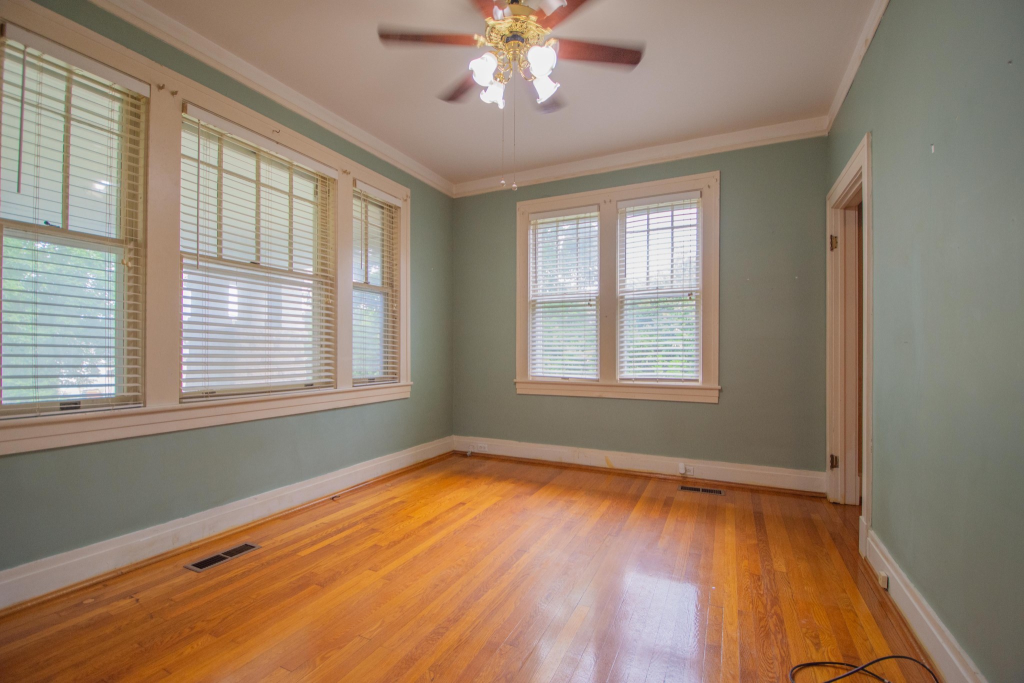 311 South 3rd Street Pulaski, TN 38478 - Photo 16 of 44 a view of an empty room with wooden floor and a window