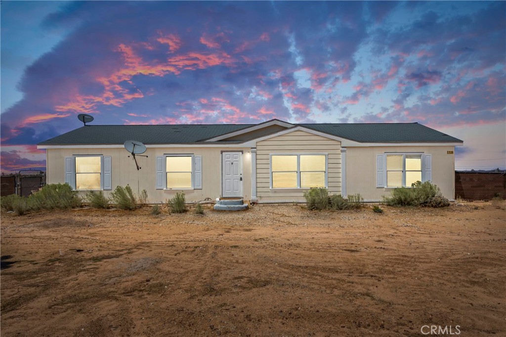 7238 Chevoit Road Phelan, CA 92371 - Photo 1 of 1 a front view of a house with a yard