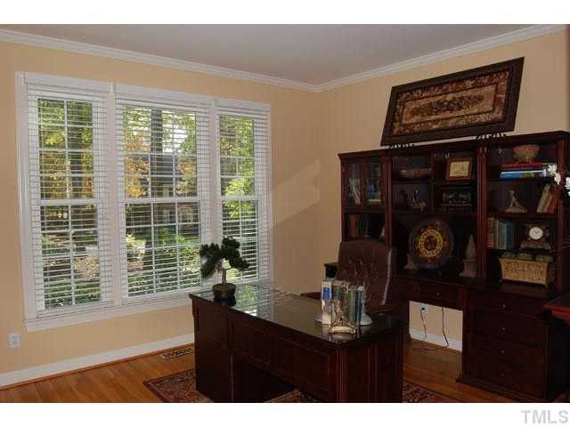 5100 Salem Ridge Road Holly Springs, NC 27540 - Photo 10 of 25 The formal living room (currently being used as an office) is wrapped with crown, grounded with hardwood floors, and features a triple window to let in lots of natural light. Living Room