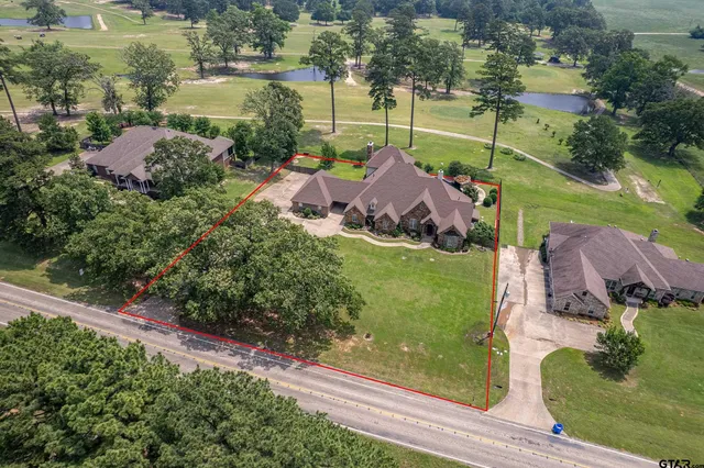 an aerial view of a house with garden space and street view