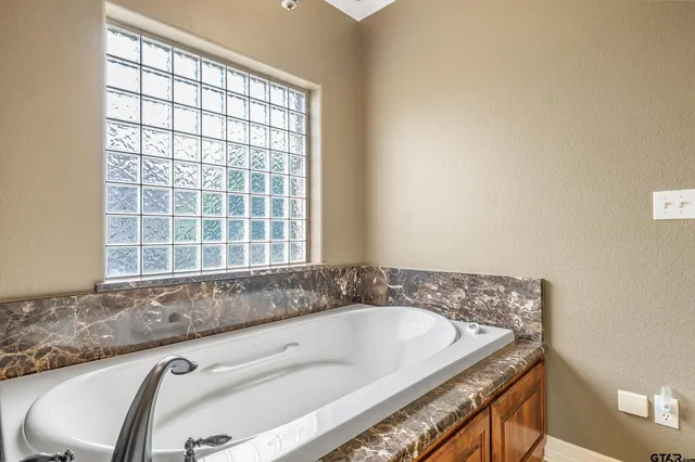 a bath tub sitting in a bathroom next to a window