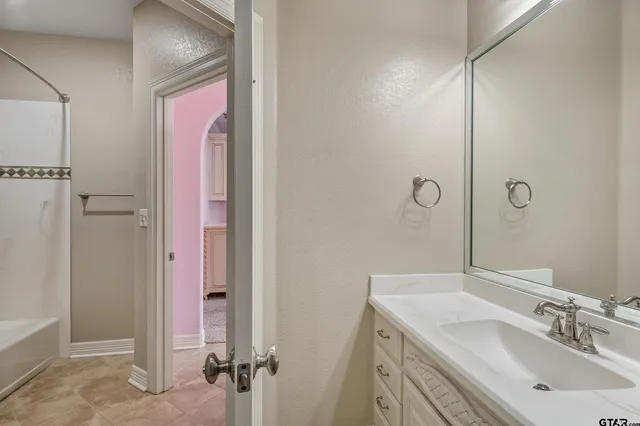 a bathroom with a sink and mirror