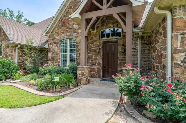 a view of a house with brick walls and potted plants