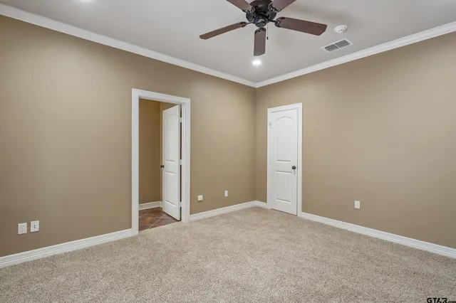 an empty room with a fan and a fan