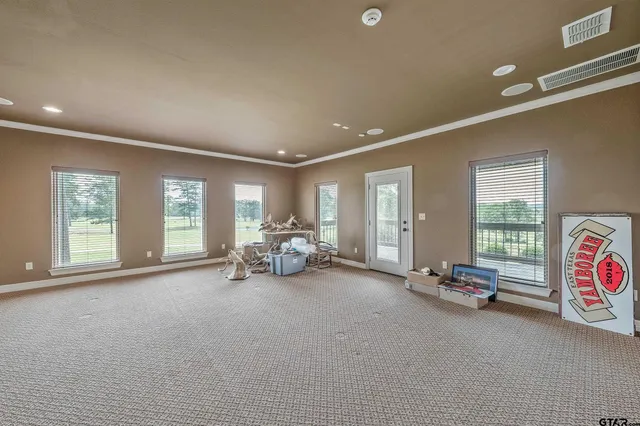 a view of a room with gym equipment and a large window