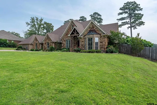 an aerial view of a house with outdoor space and lake view