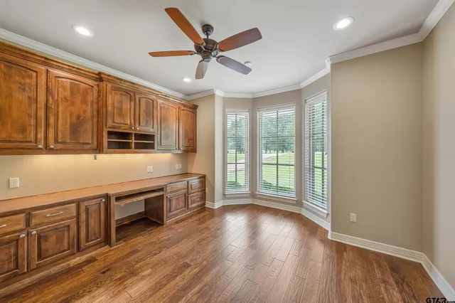 a large kitchen with stainless steel appliances granite countertop a stove and a wooden floors