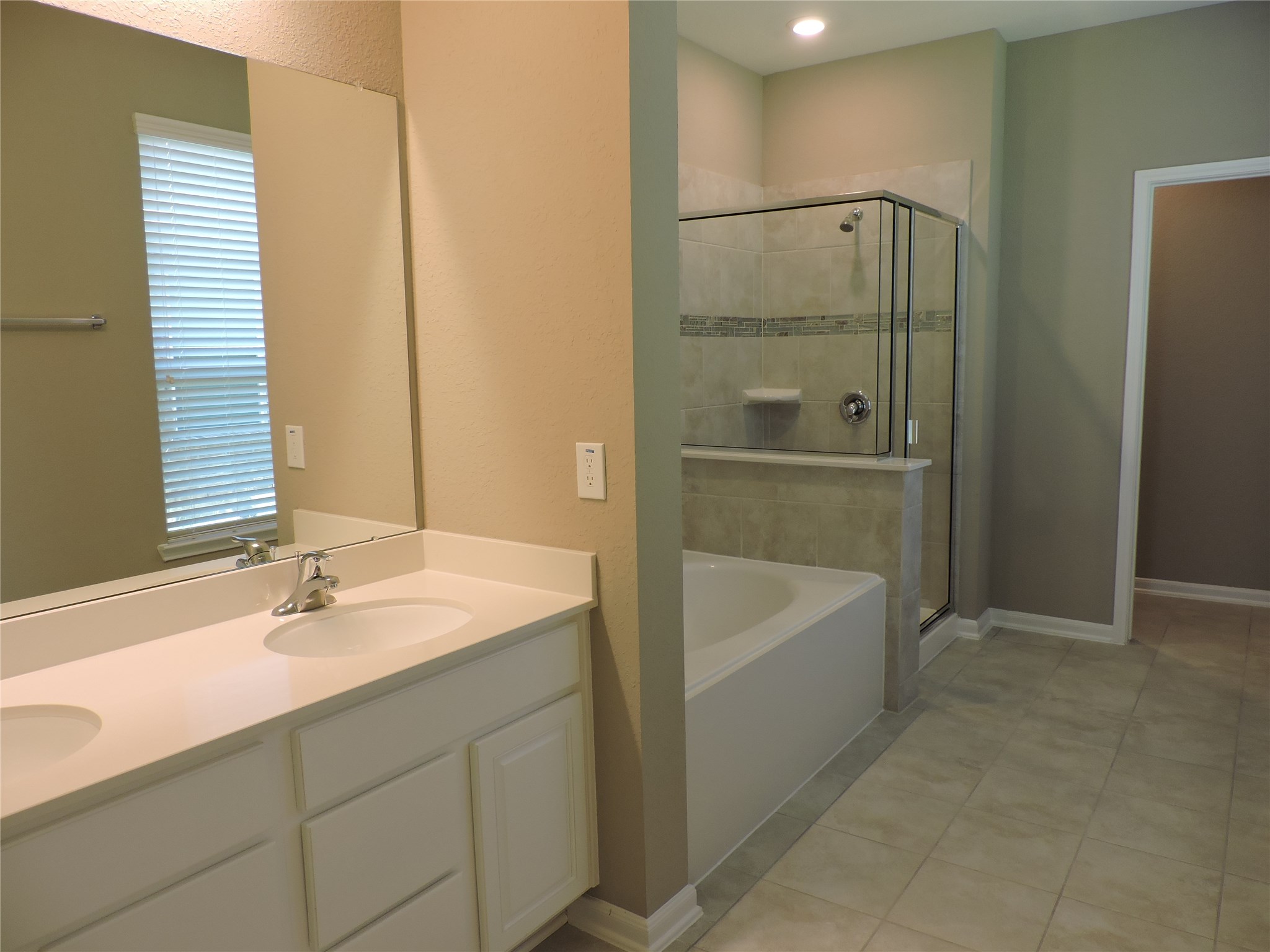 1102 Upton Court Conroe, TX 77304 - Photo 12 of 30 a bathroom with a tub sink and mirror