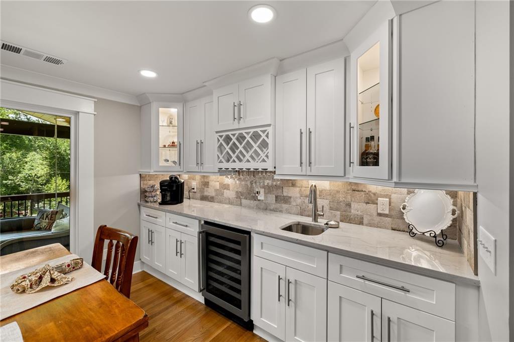 6470 Samoa Way Flowery Branch, GA 30542 - Photo 26 of 61 a kitchen with stainless steel appliances granite countertop a sink and cabinets