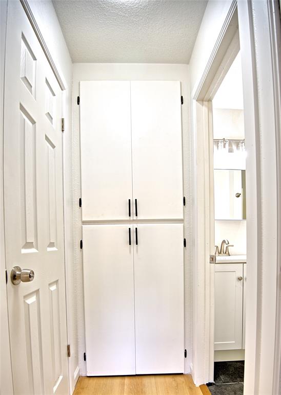 607 Baylor Street Nocona, TX 76255 - Photo 13 of 23 a view of a walk in closet with wooden floor