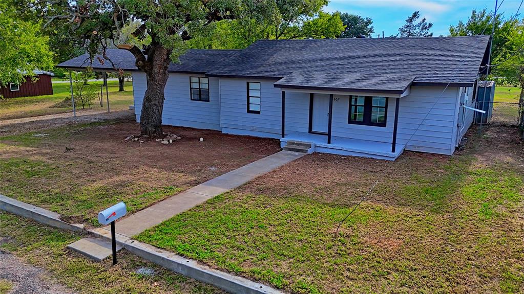 607 Baylor Street Nocona, TX 76255 - Photo 2 of 23 a front view of a house with garden