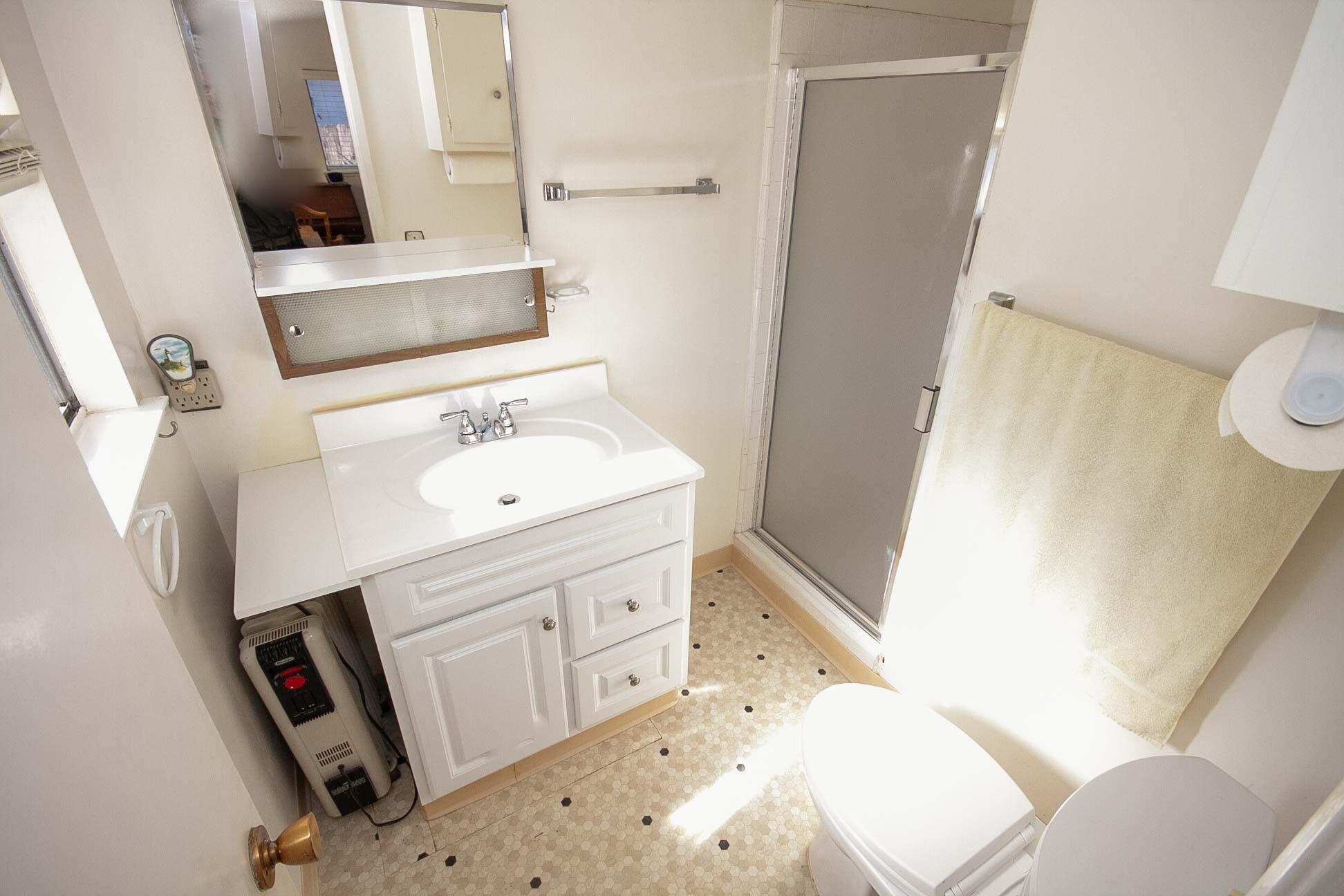 648 Dara Road Goleta, CA 93117 - Photo 9 of 14 a bathroom with a sink a toilet and a mirror