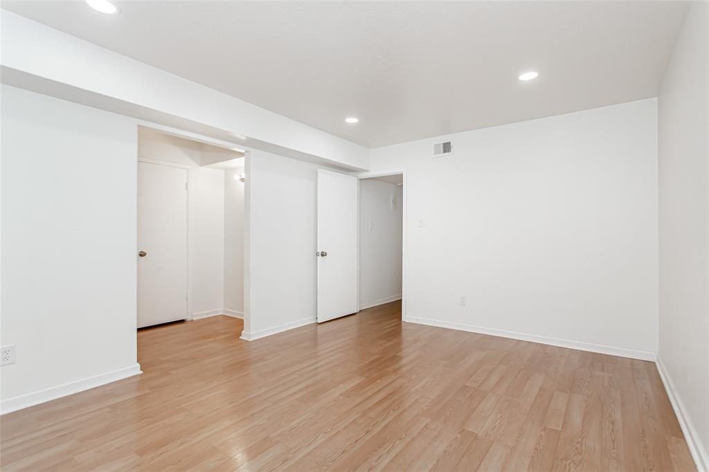 6061 Milton Street, Unit 231 Dallas, TX 75206 - Photo 11 of 27 Spacious primary suite with updated flooring, recessed lighting, and generous proportions rarely found at this price point.