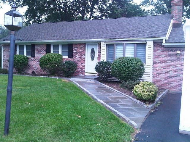 a front view of a house with garden