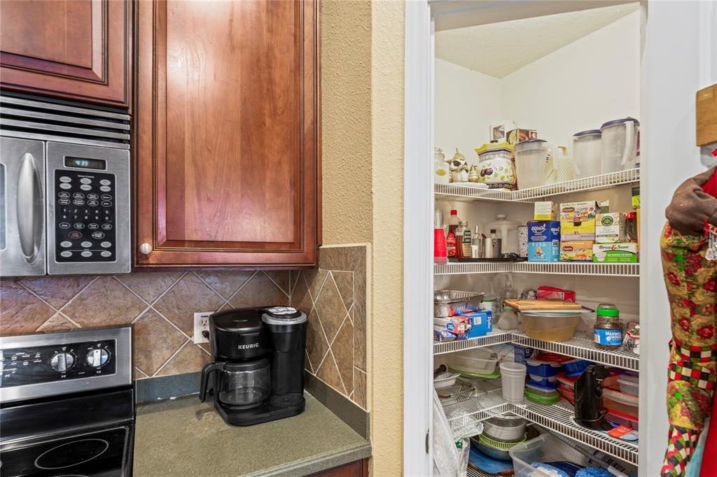 8604 Great Egret Trace New Port Richey, FL 34653 - Photo 12 of 55 a kitchen with a refrigerator and a stove top oven