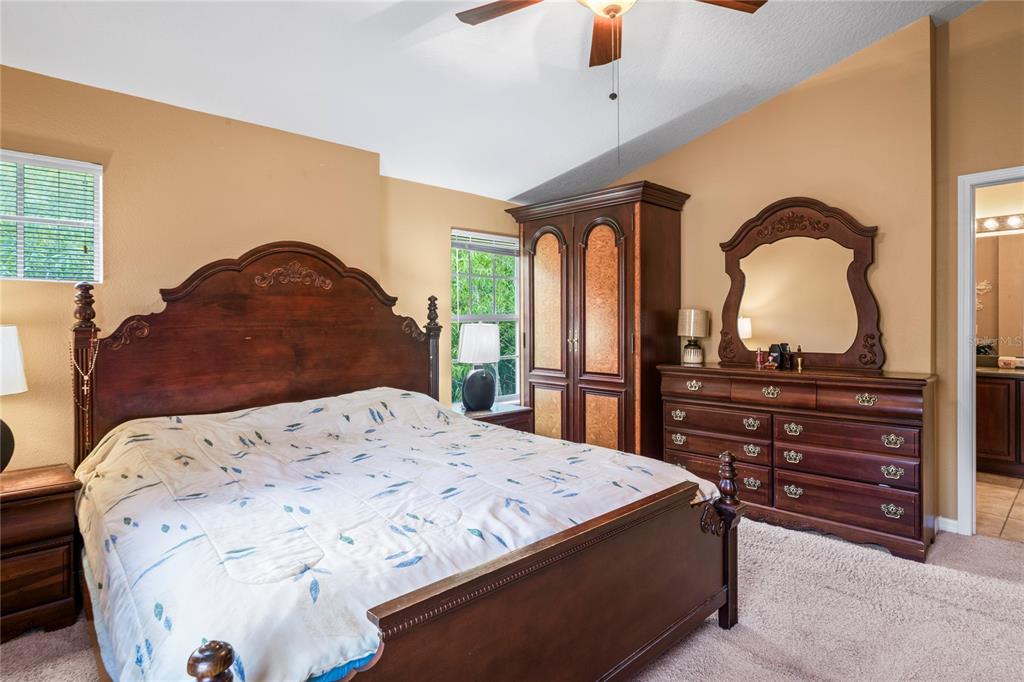 8604 Great Egret Trace New Port Richey, FL 34653 - Photo 18 of 55 a bedroom with a bed and a dresser