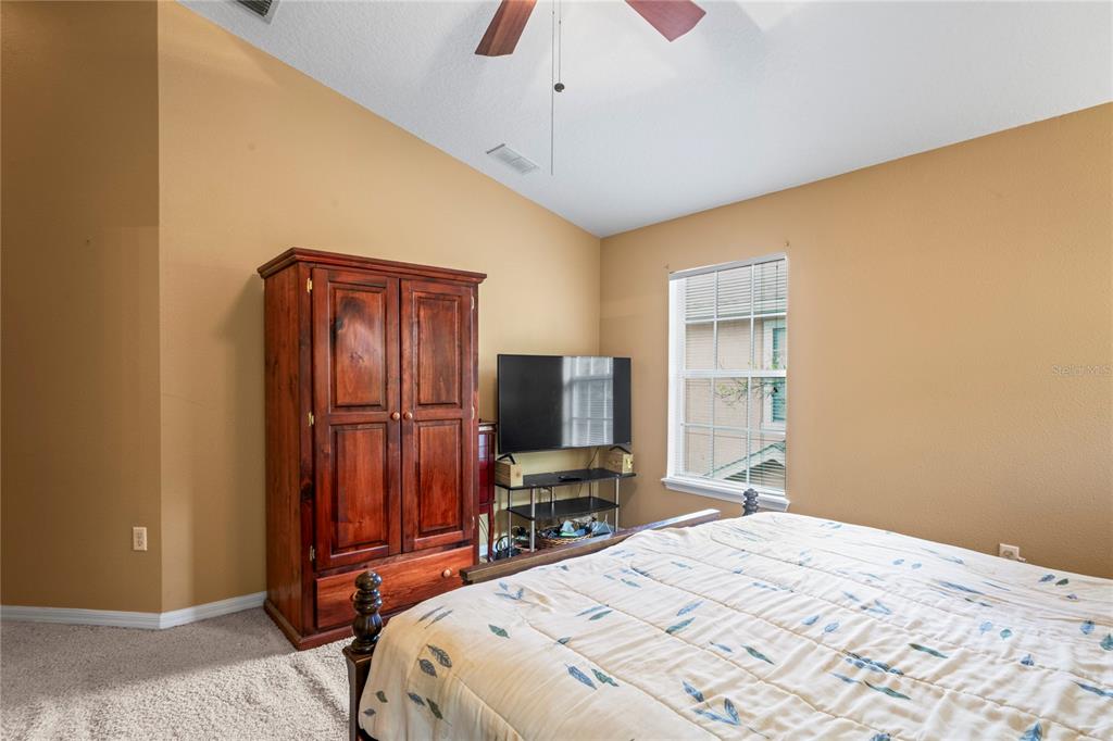 8604 Great Egret Trace New Port Richey, FL 34653 - Photo 19 of 55 a bedroom with a bed and furniture