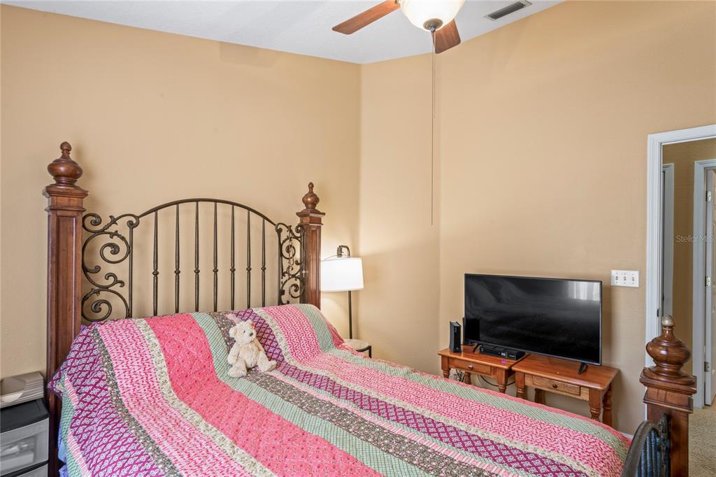 8604 Great Egret Trace New Port Richey, FL 34653 - Photo 30 of 55 a bedroom with a bed and a flat screen tv