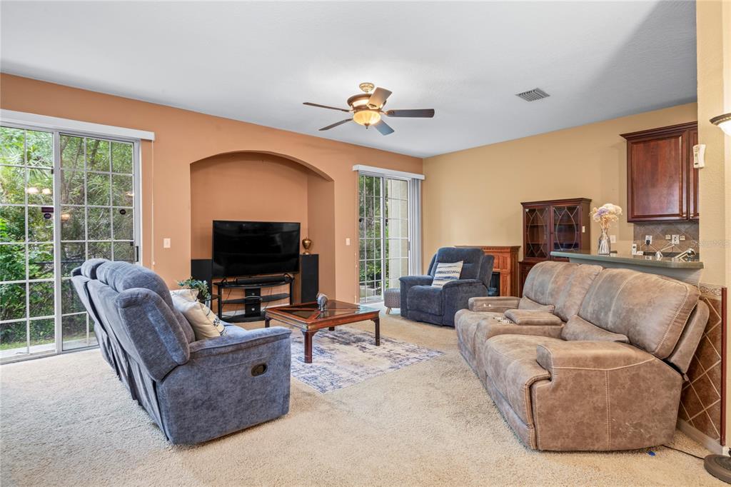 8604 Great Egret Trace New Port Richey, FL 34653 - Photo 5 of 55 a living room with furniture and a flat screen tv