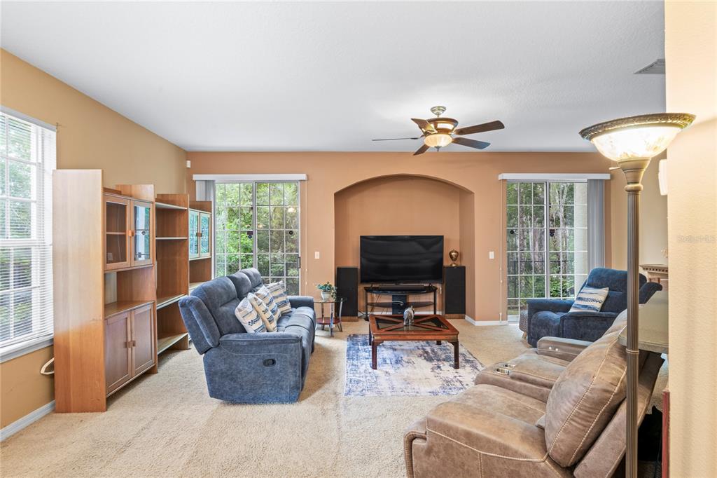 8604 Great Egret Trace New Port Richey, FL 34653 - Photo 6 of 55 a living room with furniture and a flat screen tv