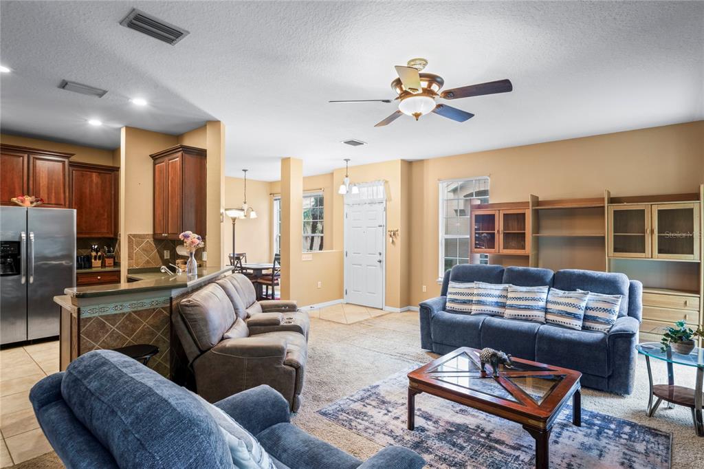8604 Great Egret Trace New Port Richey, FL 34653 - Photo 7 of 55 a living room with furniture a ceiling fan and a window
