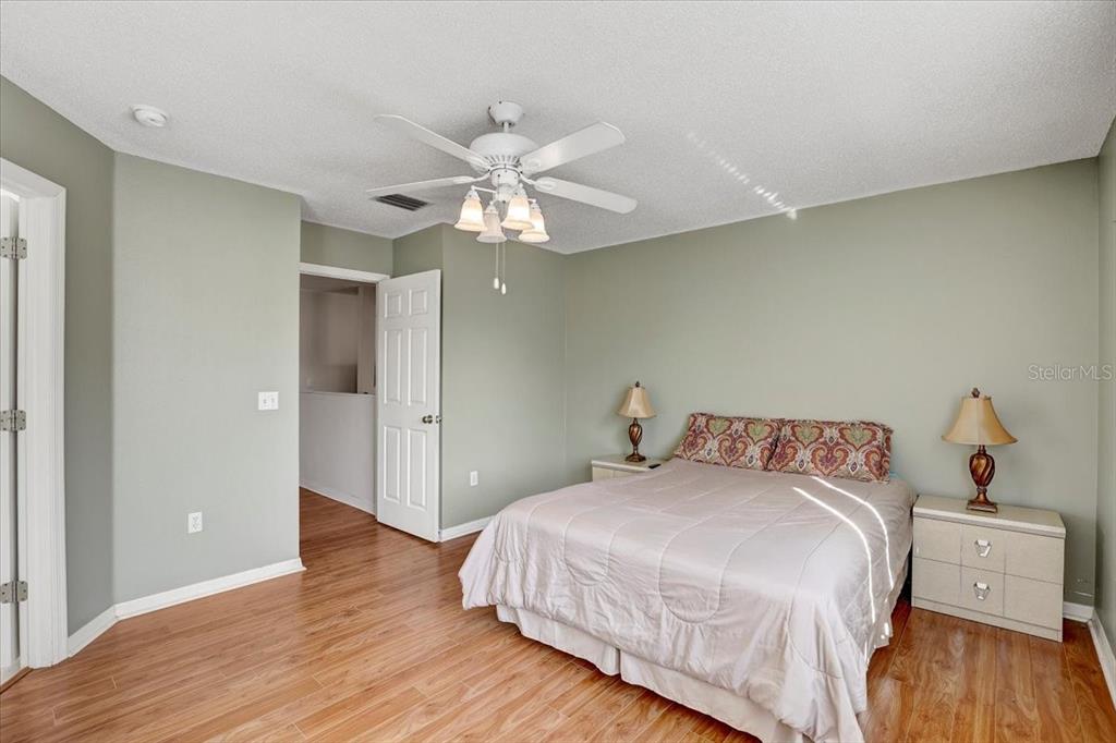 12657 Longcrest Drive Riverview, FL 33579 - Photo 17 of 55 a bedroom with a bed and wooden floor