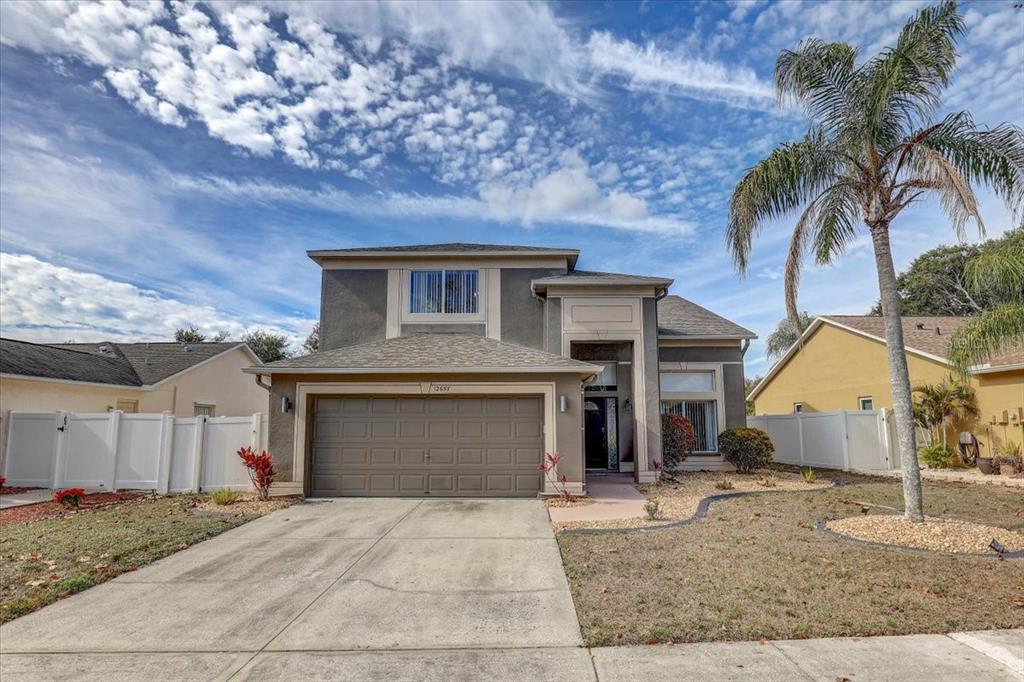 12657 Longcrest Drive Riverview, FL 33579 - Photo 2 of 55 a front view of a house with a yard and garage