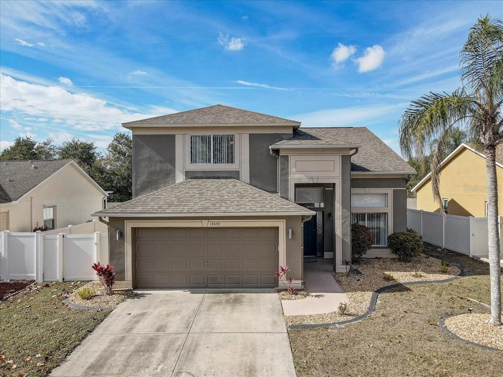 12657 Longcrest Drive Riverview, FL 33579 - Photo 21 of 55 a front view of a house with a yard and garage